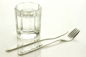 Knife and fork with a glass of water